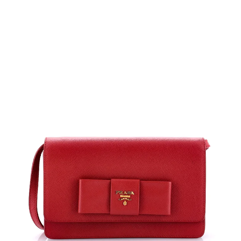 Prada Cleo bags with a contrast - colored interior for visual interestBow Wallet on Strap Saffiano Leather Small