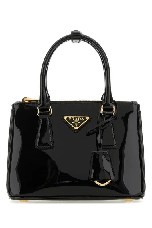 Prada Cahier bags featuring the signature triangular logo plaquePrada Woman Black Mini Galleria Leather Handbag